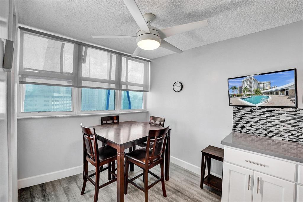 100 Golden Isles Drive, Unit 815 Hallandale Beach, FL 33009 - Photo 26 of 42 a dining room with furniture and window