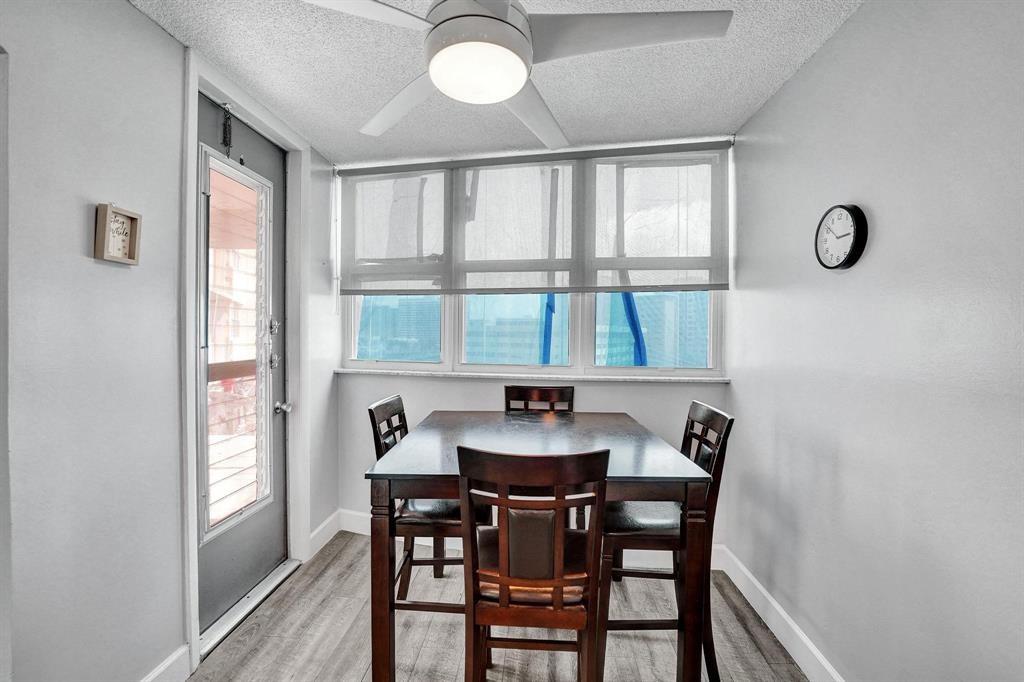 100 Golden Isles Drive, Unit 815 Hallandale Beach, FL 33009 - Photo 27 of 42 a dining room with furniture a rug and a large window