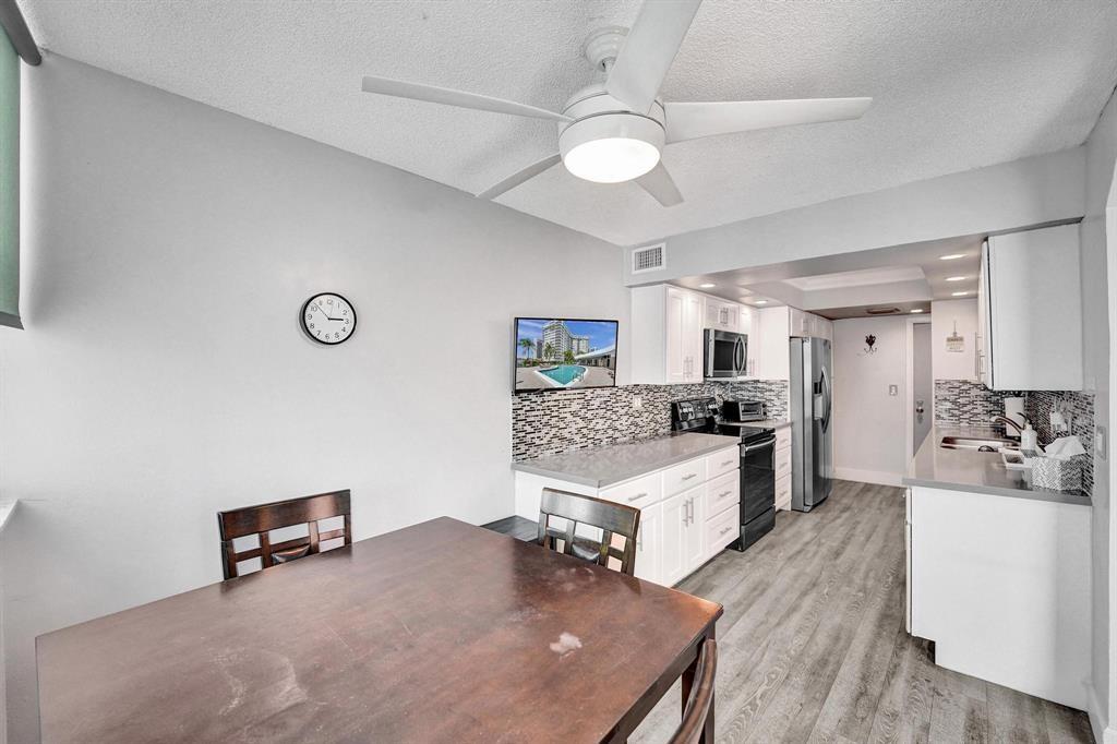 100 Golden Isles Drive, Unit 815 Hallandale Beach, FL 33009 - Photo 28 of 42 a living room with furniture and a wooden floor