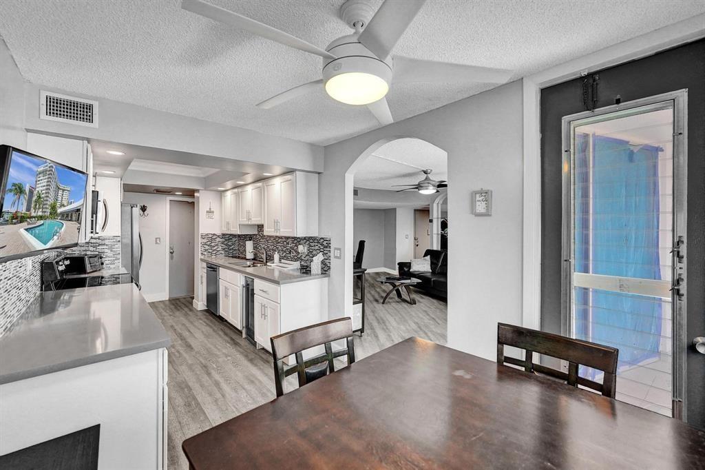100 Golden Isles Drive, Unit 815 Hallandale Beach, FL 33009 - Photo 29 of 42 a living room with furniture and a flat screen tv