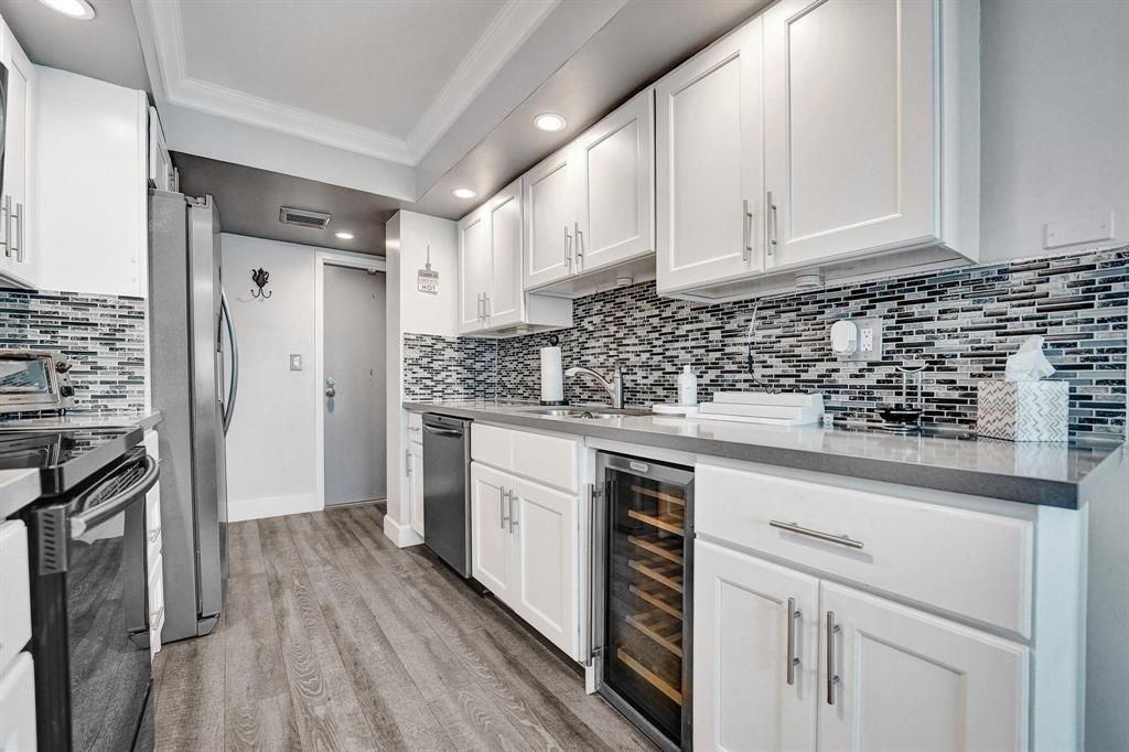 100 Golden Isles Drive, Unit 815 Hallandale Beach, FL 33009 - Photo 30 of 42 a kitchen with granite countertop white cabinets and white appliances