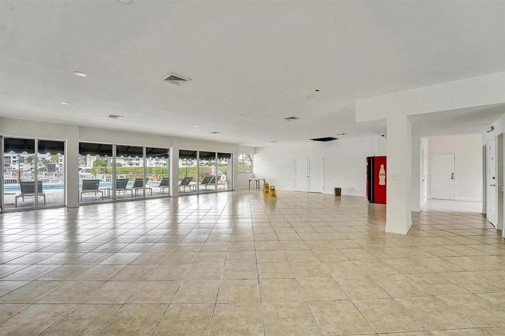100 Golden Isles Drive, Unit 815 Hallandale Beach, FL 33009 - Photo 34 of 42 a view of empty room with wooden floor and windows