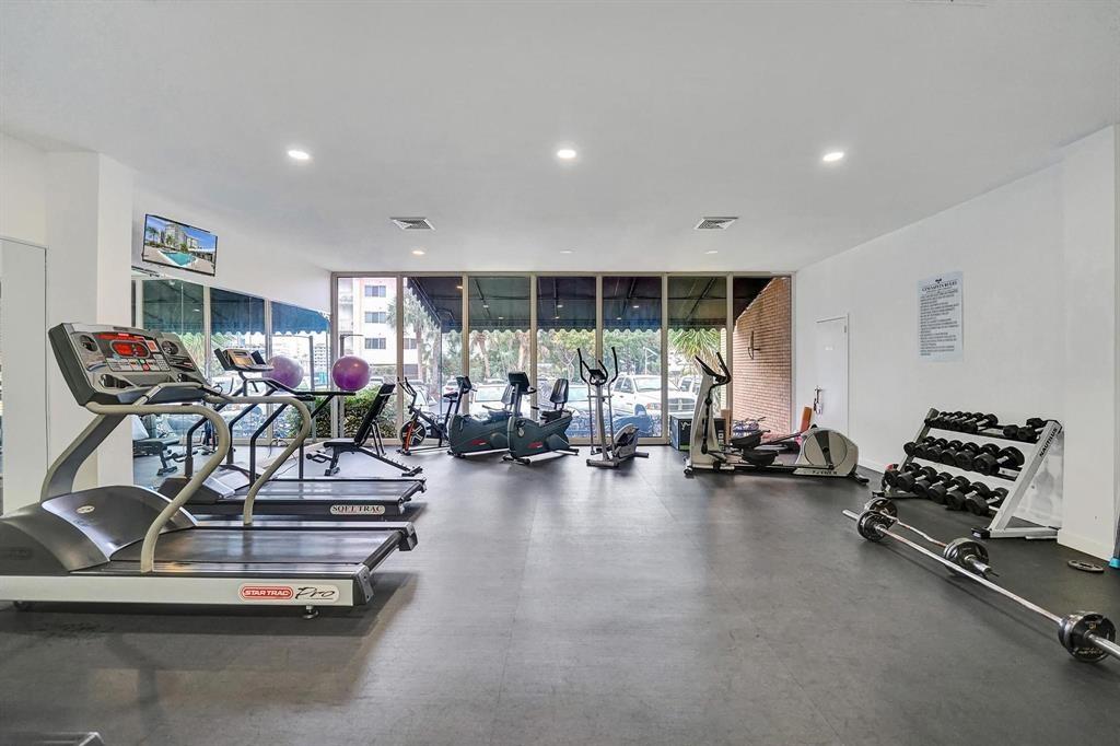 100 Golden Isles Drive, Unit 815 Hallandale Beach, FL 33009 - Photo 35 of 42 a room with gym equipment and a large window