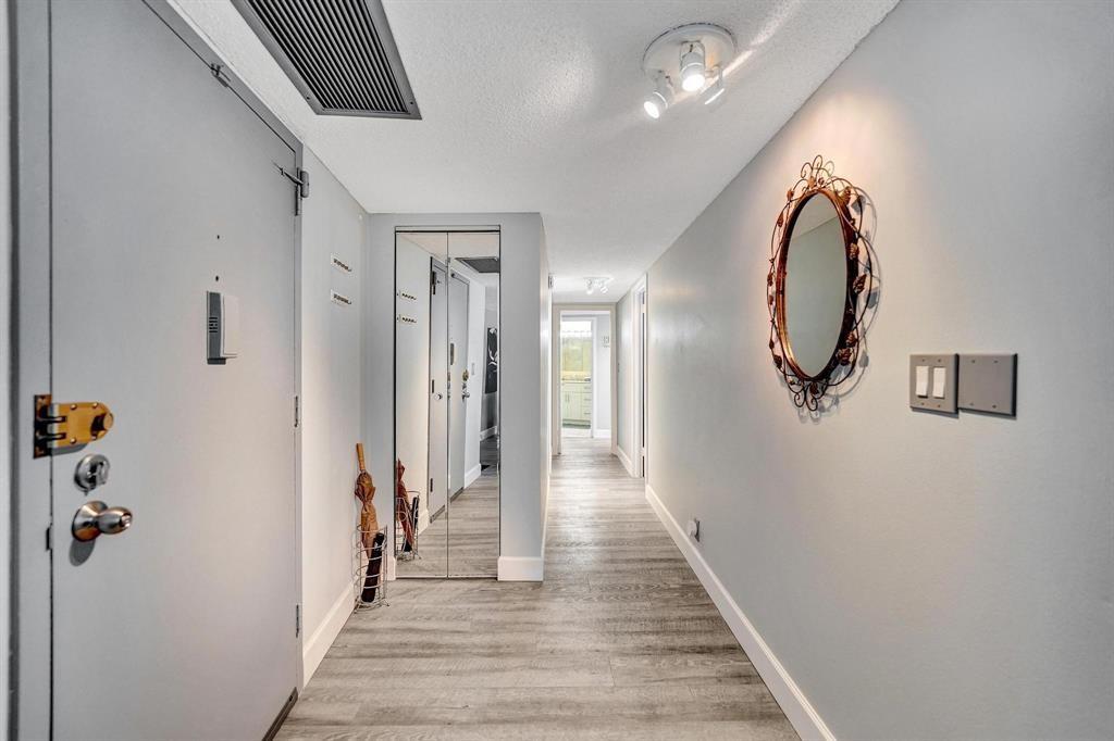 100 Golden Isles Drive, Unit 815 Hallandale Beach, FL 33009 - Photo 4 of 42 a view of a hallway with wooden floor and staircase