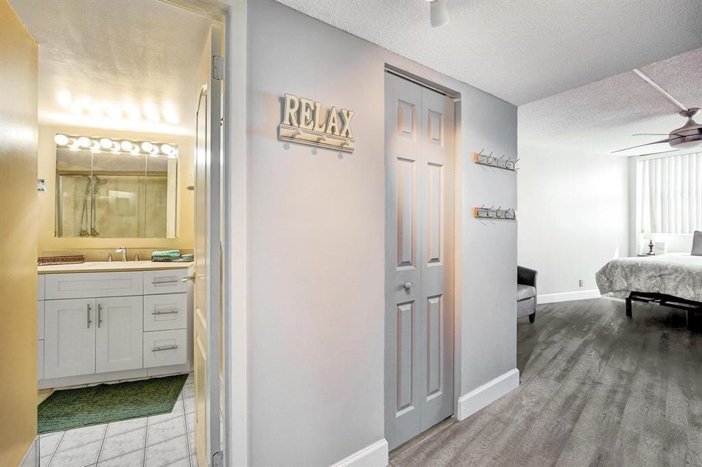 100 Golden Isles Drive, Unit 815 Hallandale Beach, FL 33009 - Photo 5 of 42 a bathroom with a sink and a mirror