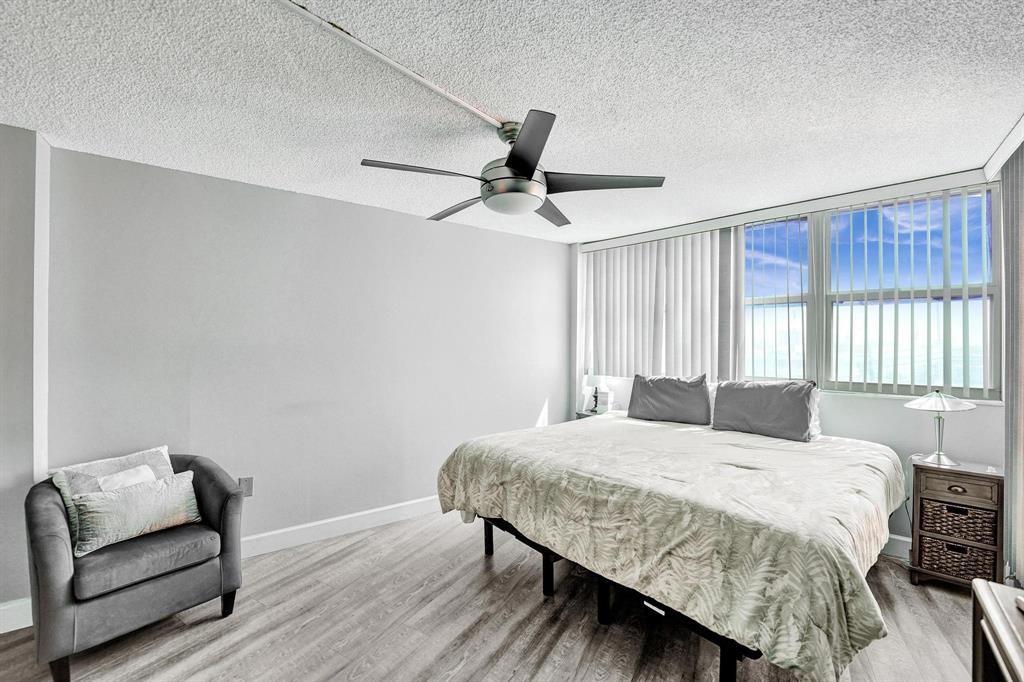 100 Golden Isles Drive, Unit 815 Hallandale Beach, FL 33009 - Photo 7 of 42 a bedroom with a bed and a couch