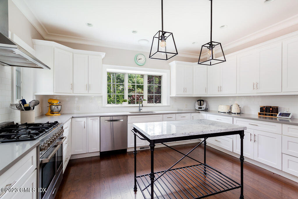 552 River Road Cos Cob, CT 06807 - Photo 11 of 35 a kitchen with stainless steel appliances granite countertop a stove a sink a refrigerator and cabinets