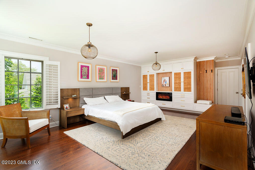 552 River Road Cos Cob, CT 06807 - Photo 17 of 35 a spacious bedroom with a bed a couch and large window