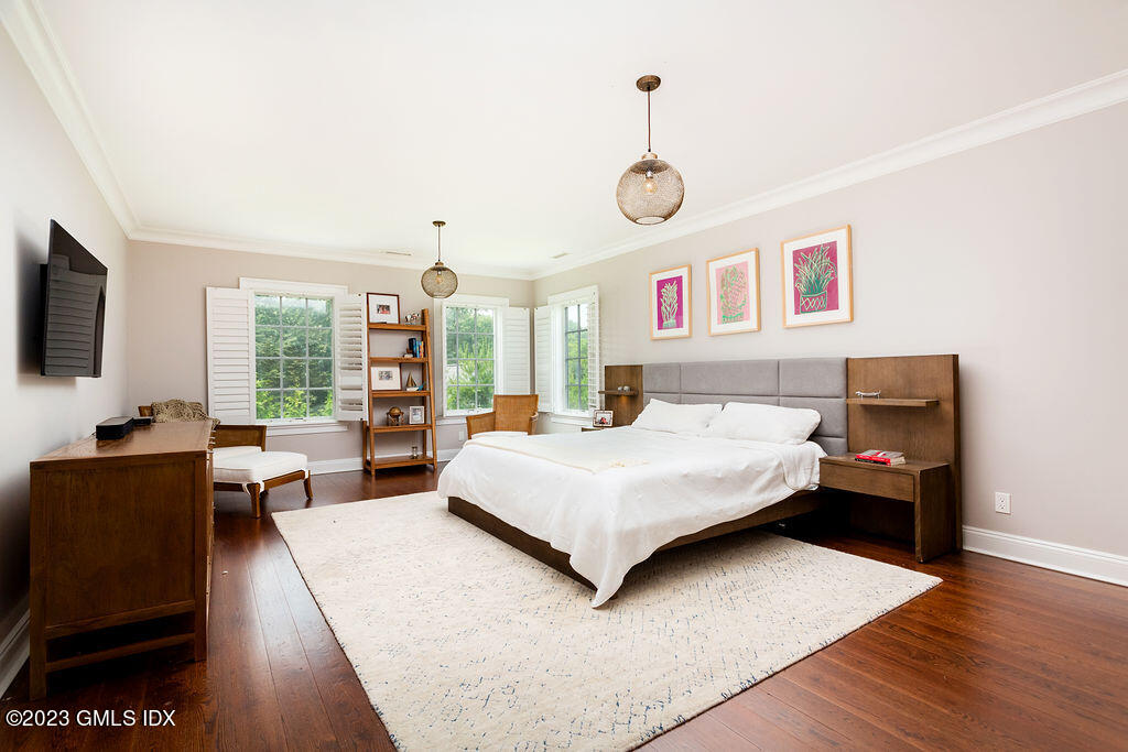 552 River Road Cos Cob, CT 06807 - Photo 18 of 35 a spacious bedroom with a bed and a large window
