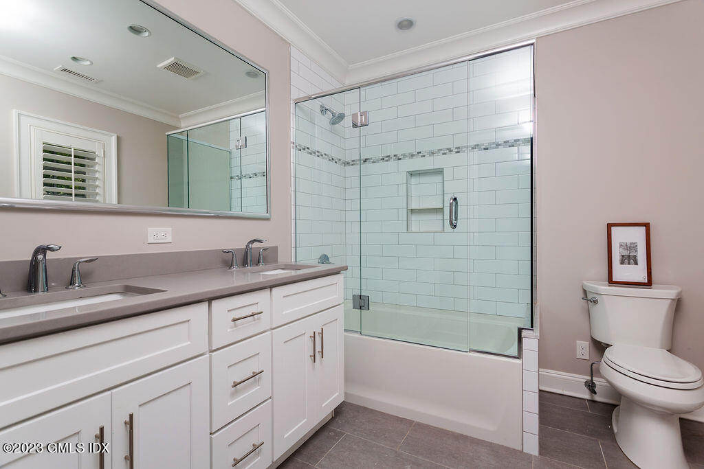 552 River Road Cos Cob, CT 06807 - Photo 21 of 35 a bathroom with a granite countertop sink mirror toilet and bathtub