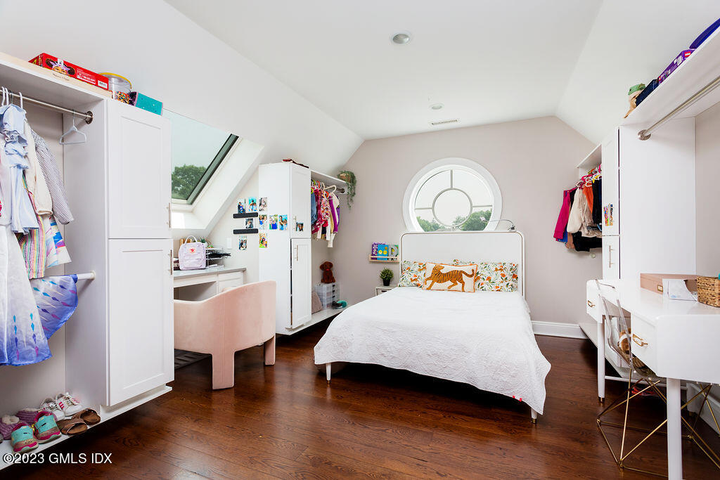 552 River Road Cos Cob, CT 06807 - Photo 23 of 35 a bedroom with a bed and a chandelier