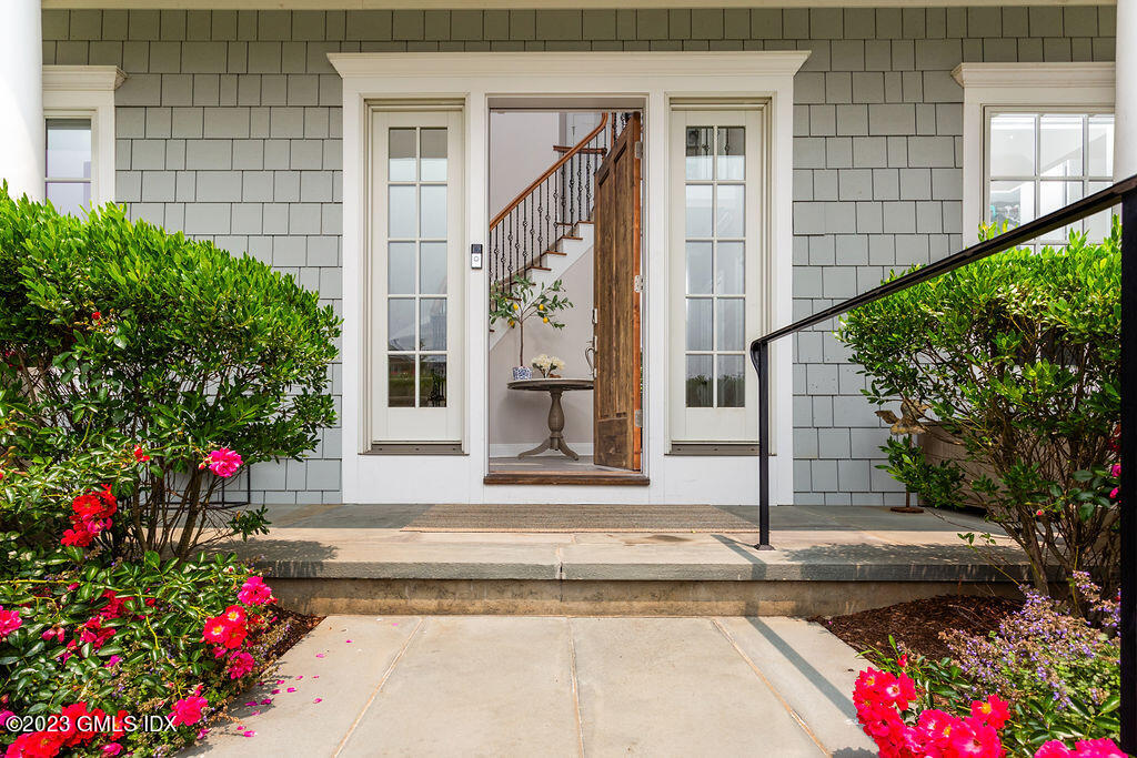 552 River Road Cos Cob, CT 06807 - Photo 3 of 35 a front view of a house with a porch