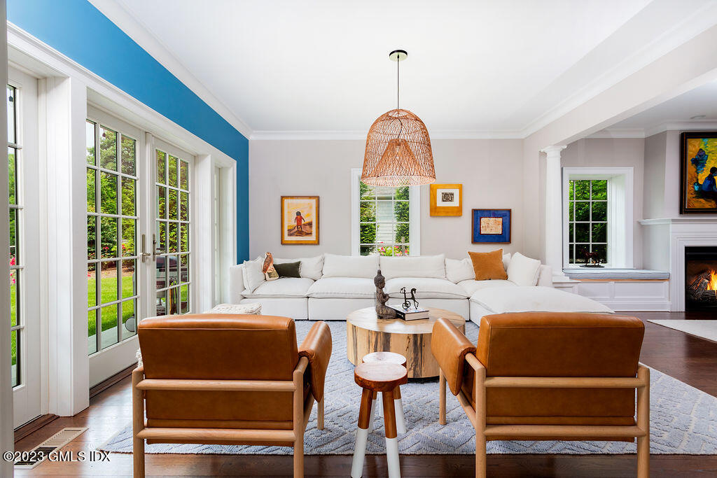 552 River Road Cos Cob, CT 06807 - Photo 7 of 35 a living room with furniture a fireplace and a chandelier