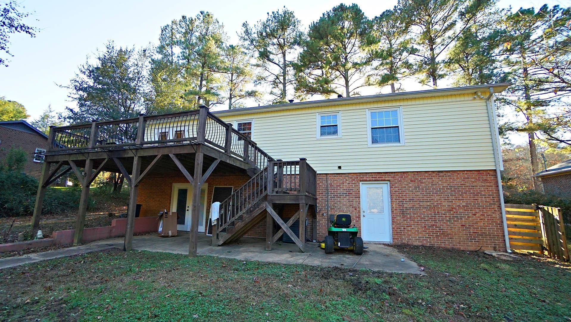 406 Snelling Road Raleigh, NC 27609 - Photo 25 of 25 Upper level deck and lower level patio lending into bonus-family room Exterior Back