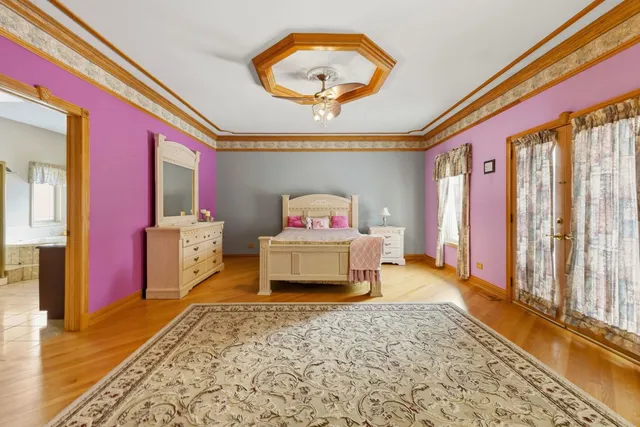 a bedroom with a bed and a chandelier