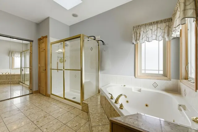 a bathroom with a bathtub and a shower