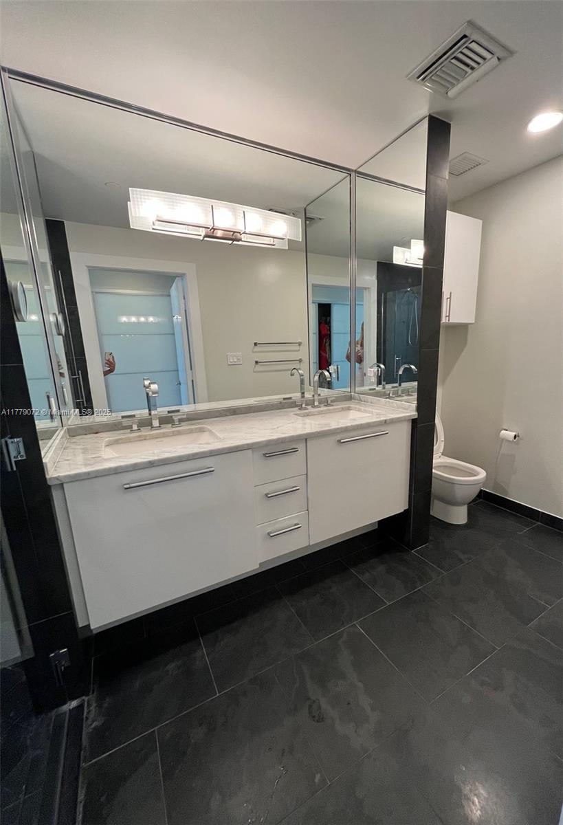 900 Biscayne Boulevard, Unit 4312 Miami, FL 33132 - Photo 11 of 36 a bathroom with a sink and a mirror