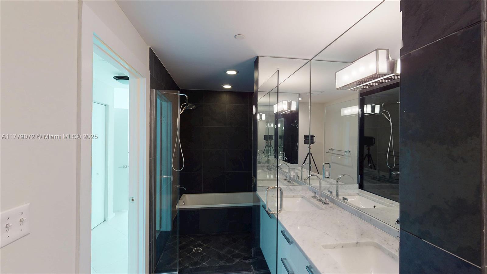 900 Biscayne Boulevard, Unit 4312 Miami, FL 33132 - Photo 12 of 36 a bathroom with a double vanity sink toilet and shower