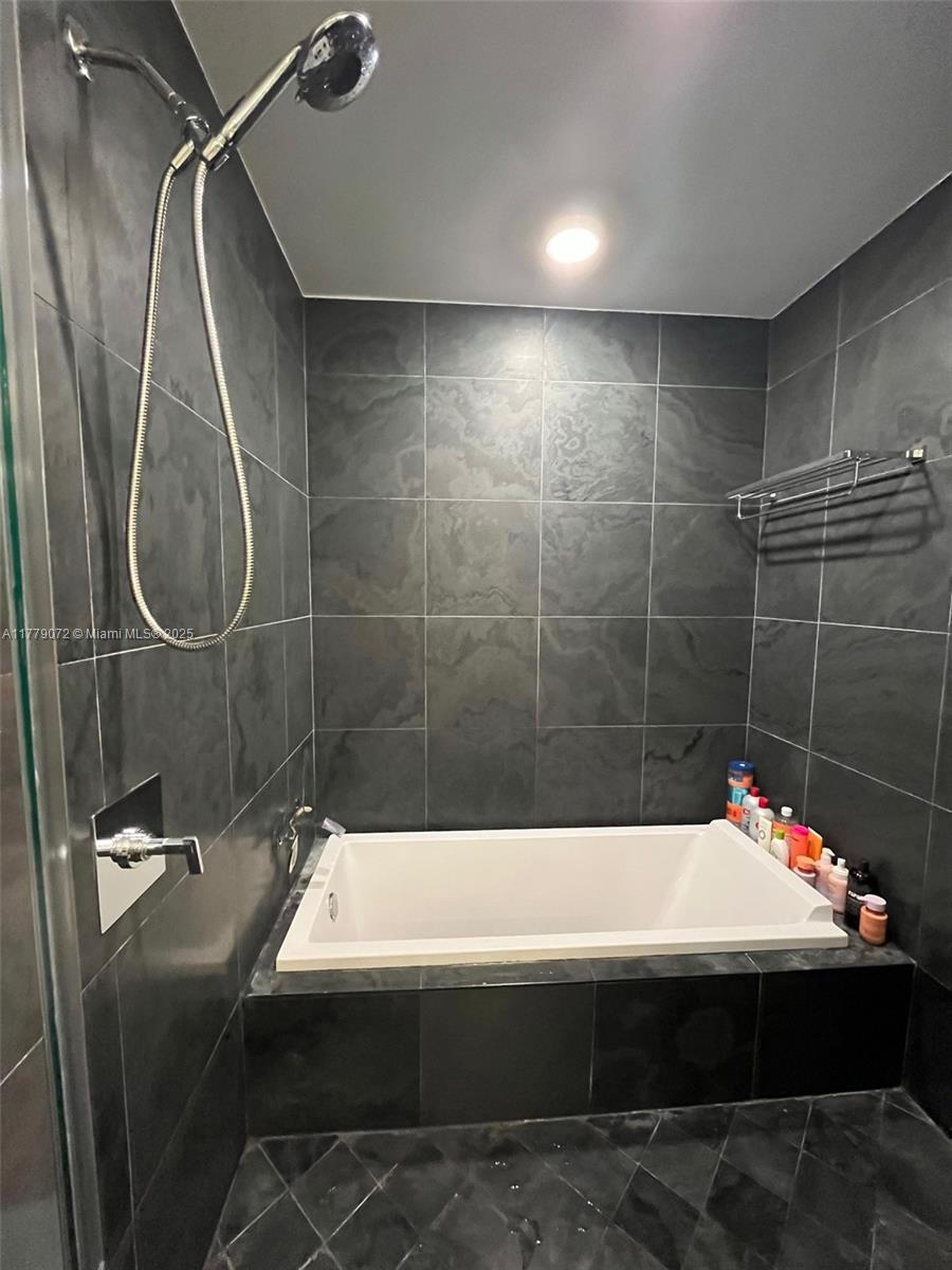 900 Biscayne Boulevard, Unit 4312 Miami, FL 33132 - Photo 13 of 36 a bathroom with a sink and mirror