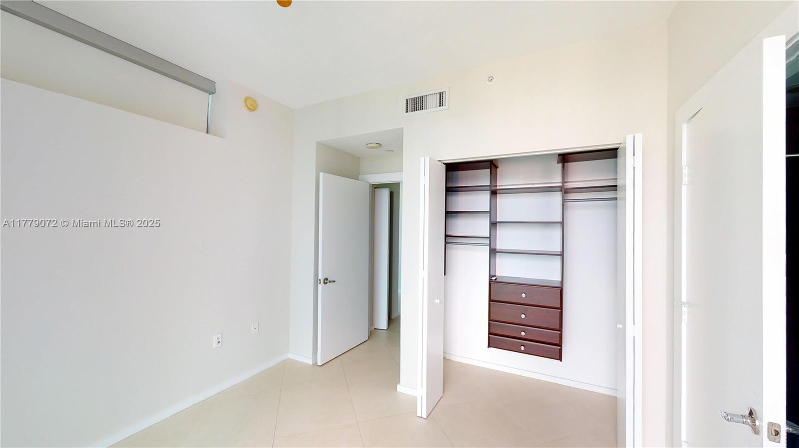 900 Biscayne Boulevard, Unit 4312 Miami, FL 33132 - Photo 16 of 36 a view of walk in closet with empty racks