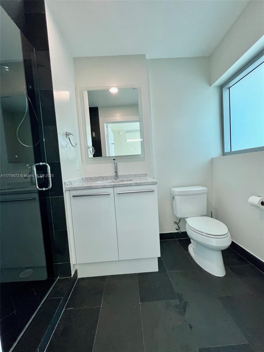 900 Biscayne Boulevard, Unit 4312 Miami, FL 33132 - Photo 17 of 36 a white toilet sitting next to a bathroom sink