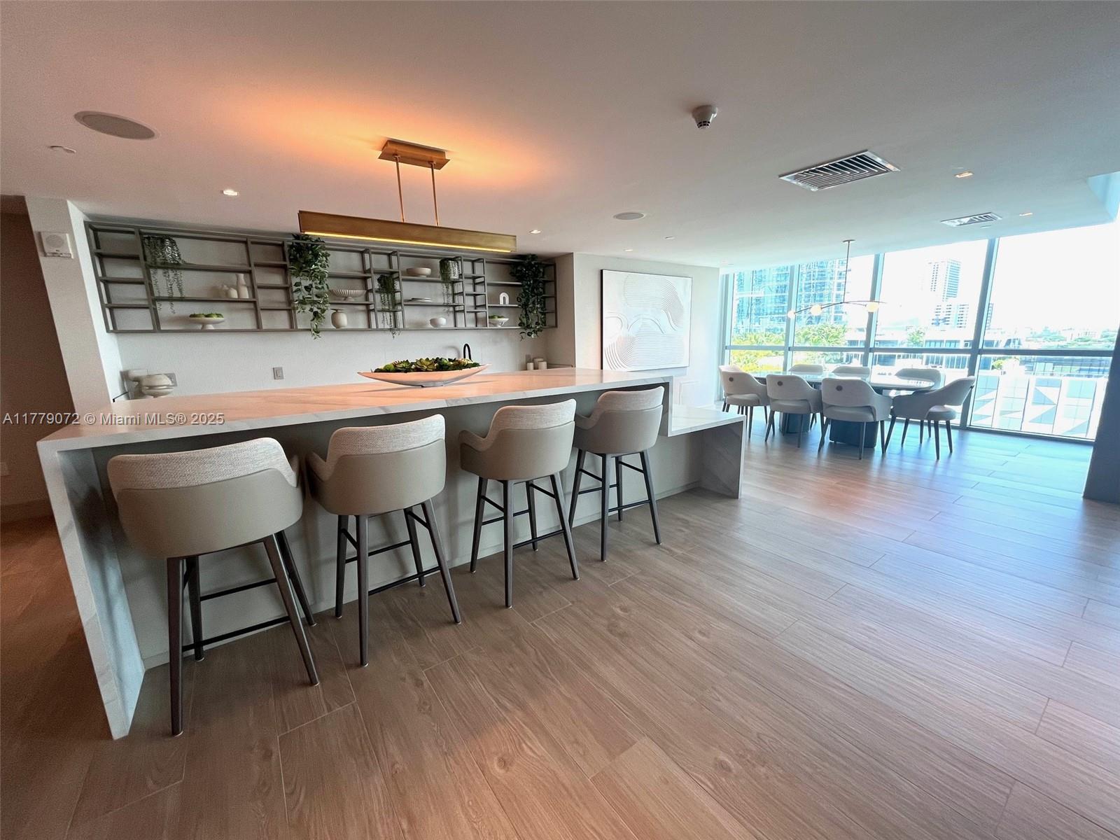 900 Biscayne Boulevard, Unit 4312 Miami, FL 33132 - Photo 29 of 36 a dining table with chairs and wooden floor