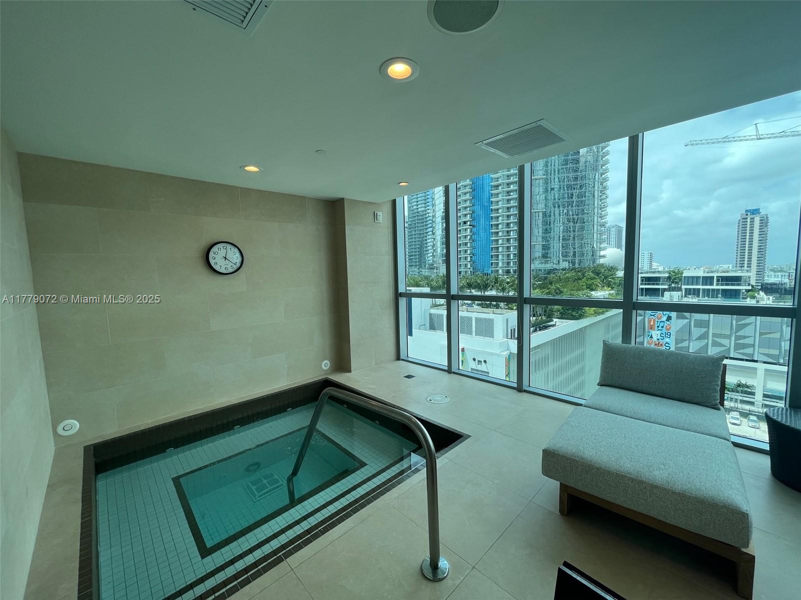 900 Biscayne Boulevard, Unit 4312 Miami, FL 33132 - Photo 31 of 36 a living room with furniture and a floor to ceiling window