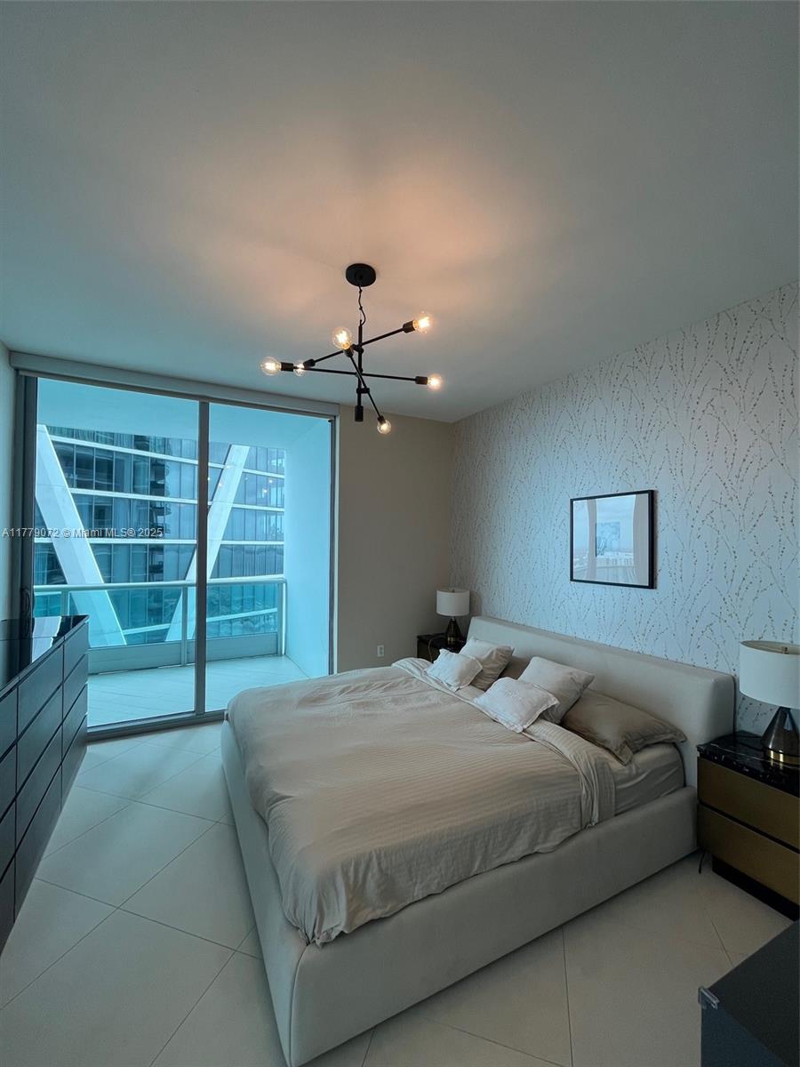 900 Biscayne Boulevard, Unit 4312 Miami, FL 33132 - Photo 8 of 36 a bedroom with a large bed and a window