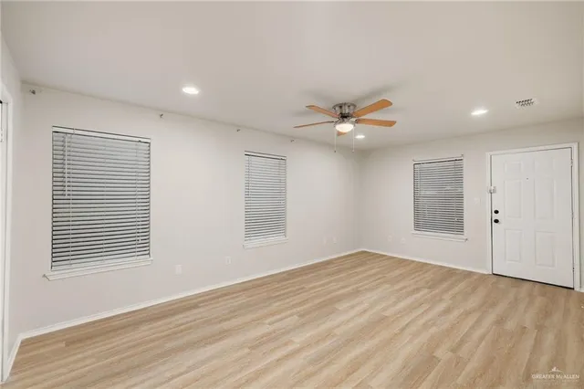 a view of a livingroom with a ceiling fan and window