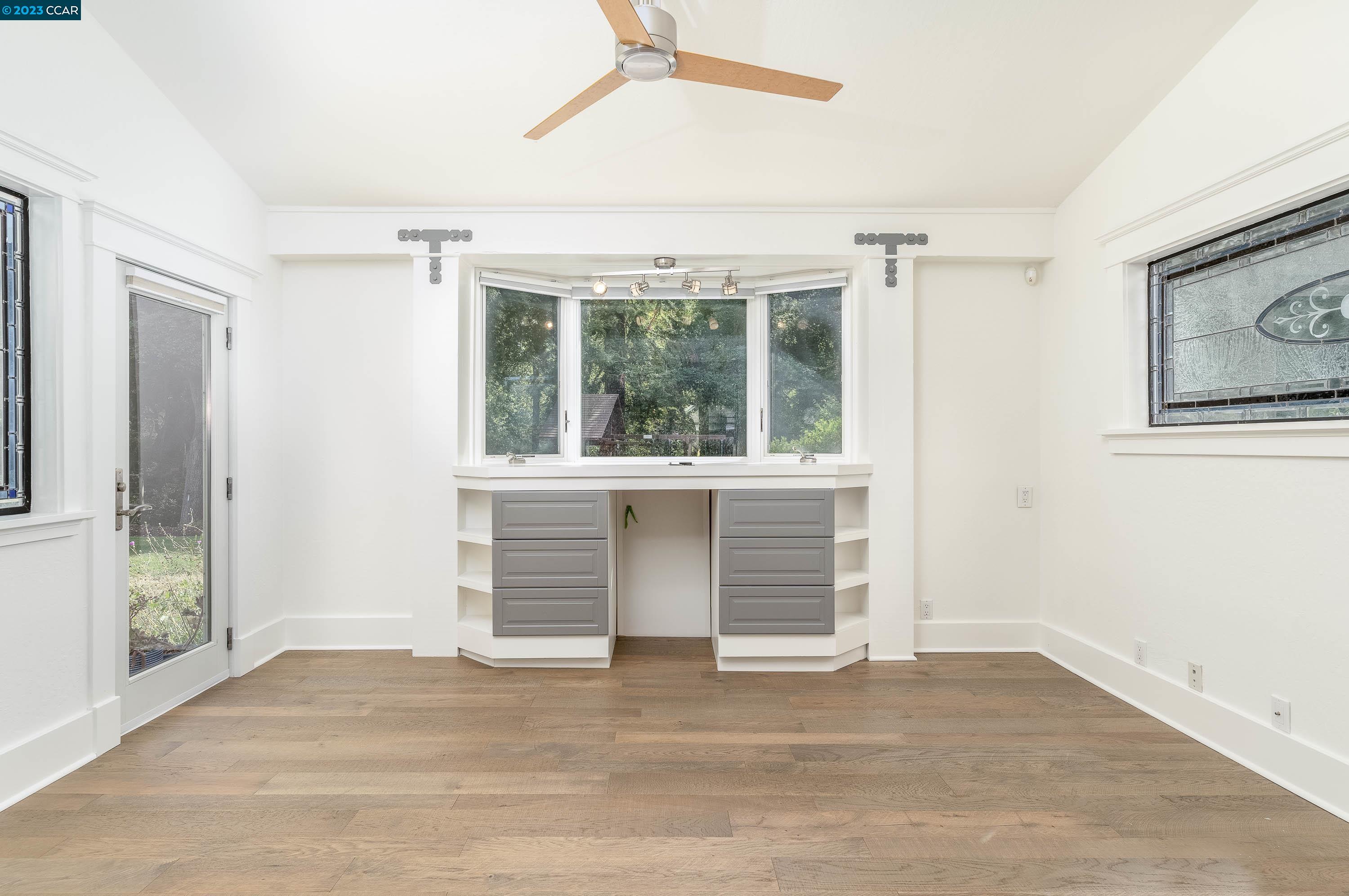 1206 Rimer Drive Moraga, CA 94556 - Photo 16 of 53 an empty room with a fireplace and windows