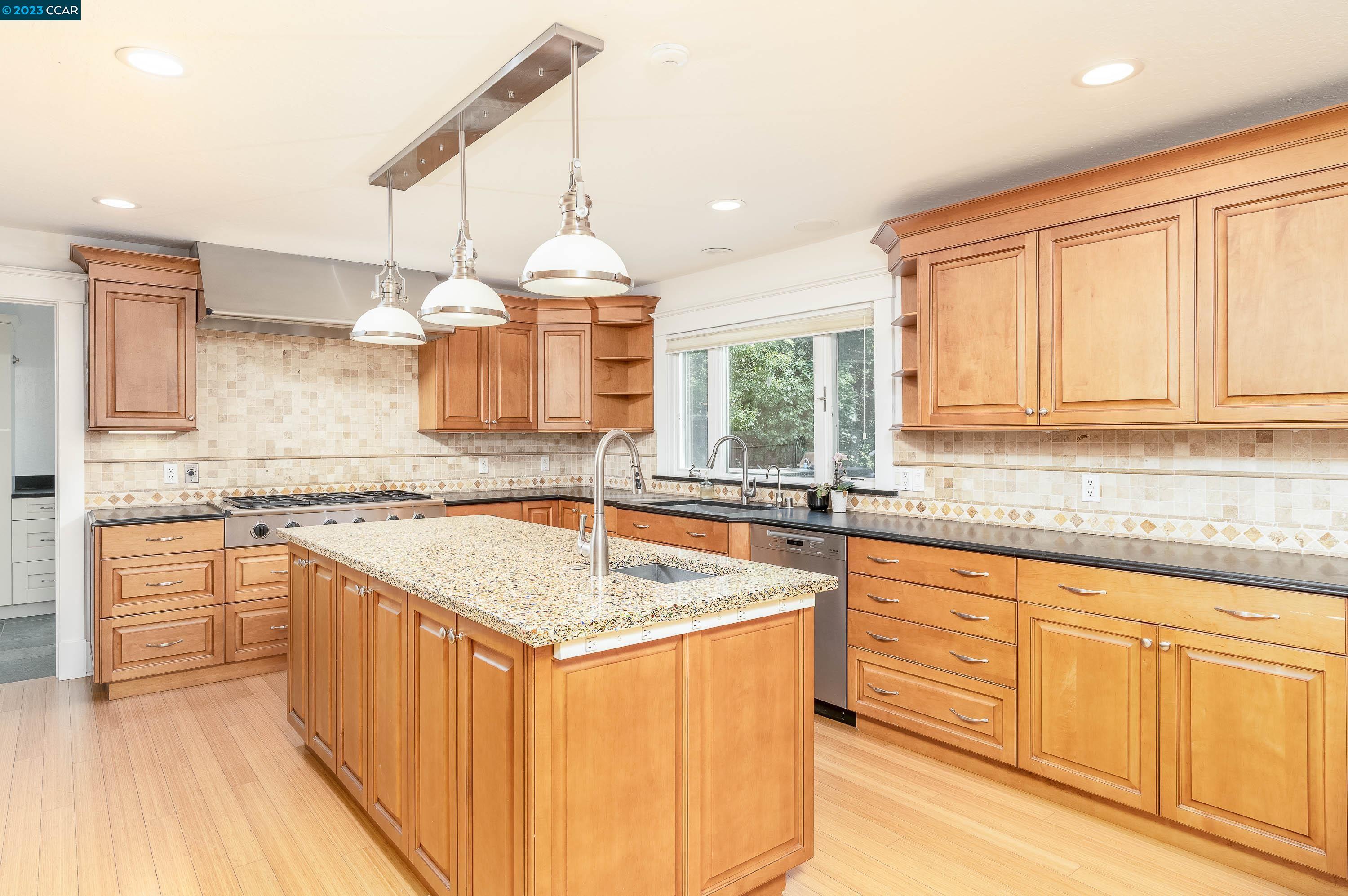 1206 Rimer Drive Moraga, CA 94556 - Photo 10 of 53 a kitchen with stainless steel appliances granite countertop a sink a stove and a wooden cabinets