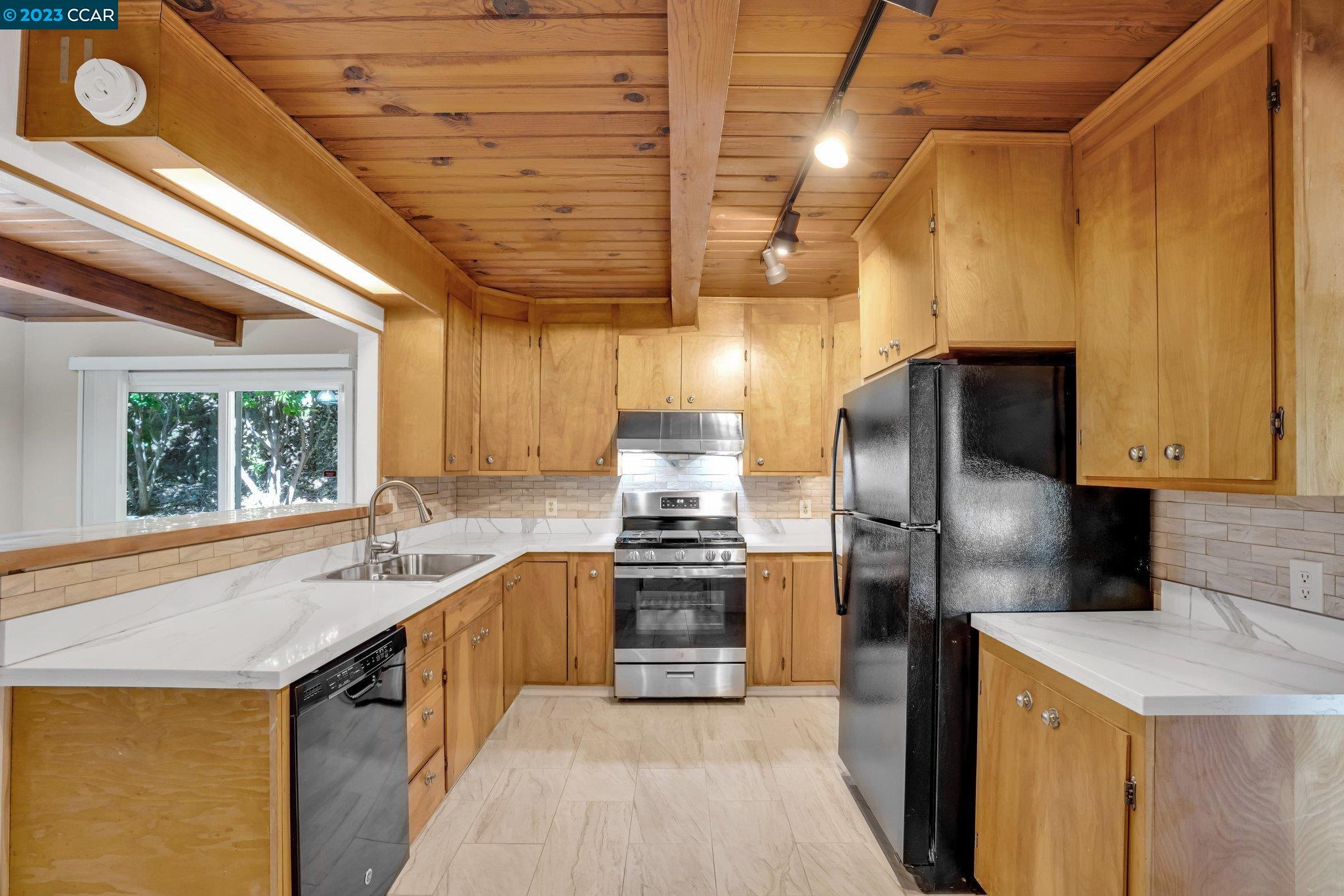 928 Janet Lane Lafayette, CA 94549 - Photo 13 of 33 a kitchen with stainless steel appliances granite countertop a sink a stove and a refrigerator
