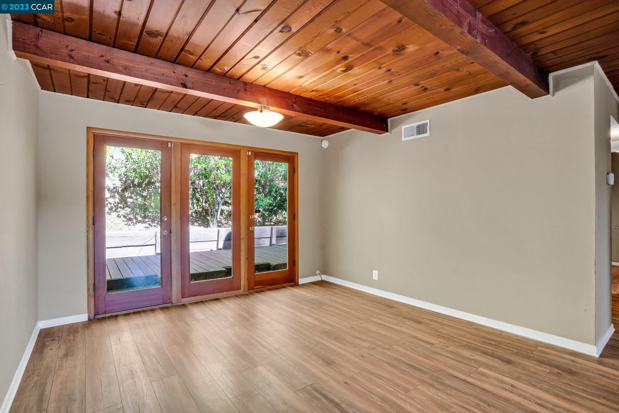 928 Janet Lane Lafayette, CA 94549 - Photo 16 of 33 an empty room with wooden floor and windows