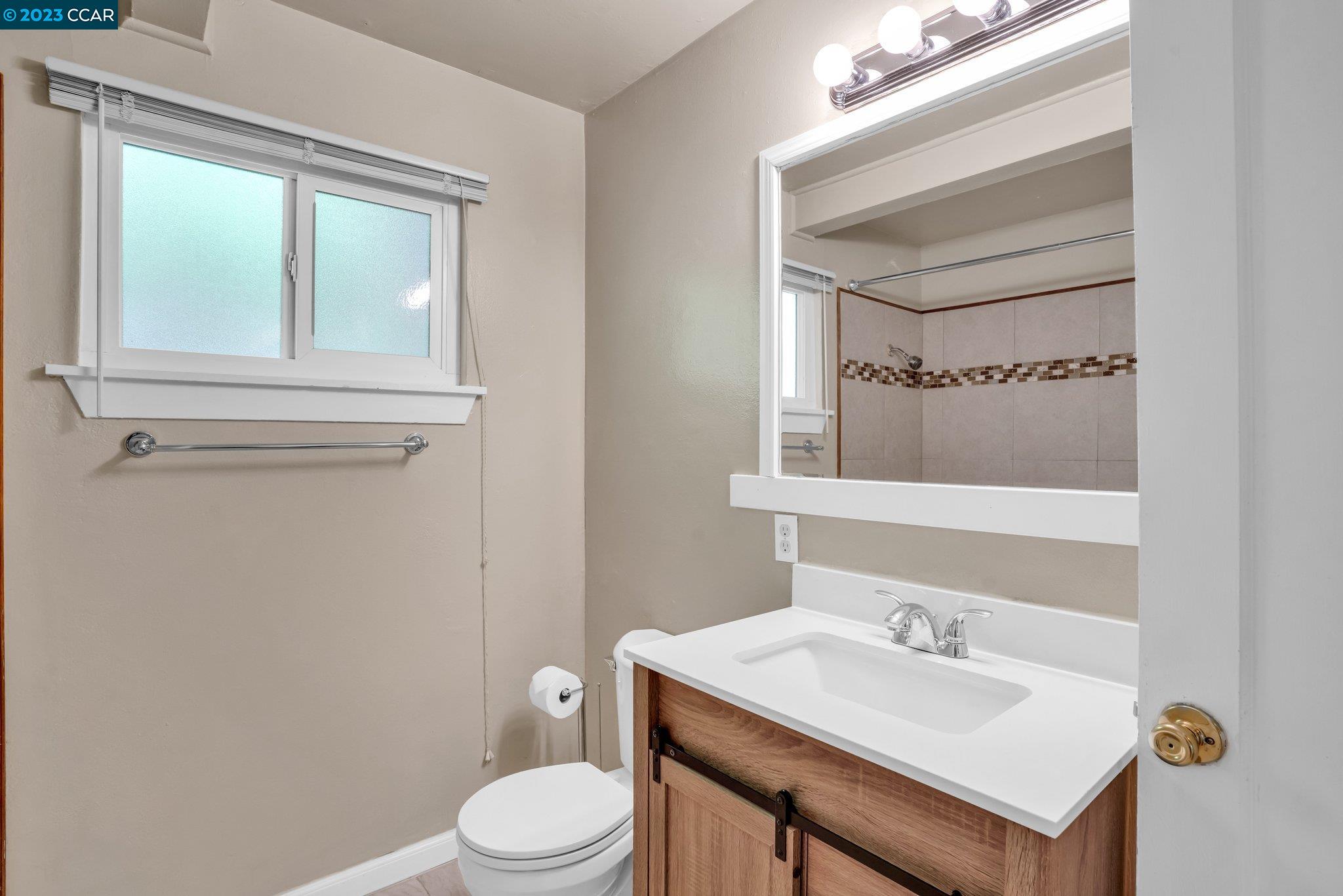 928 Janet Lane Lafayette, CA 94549 - Photo 21 of 33 a bathroom with a sink a toilet and mirror