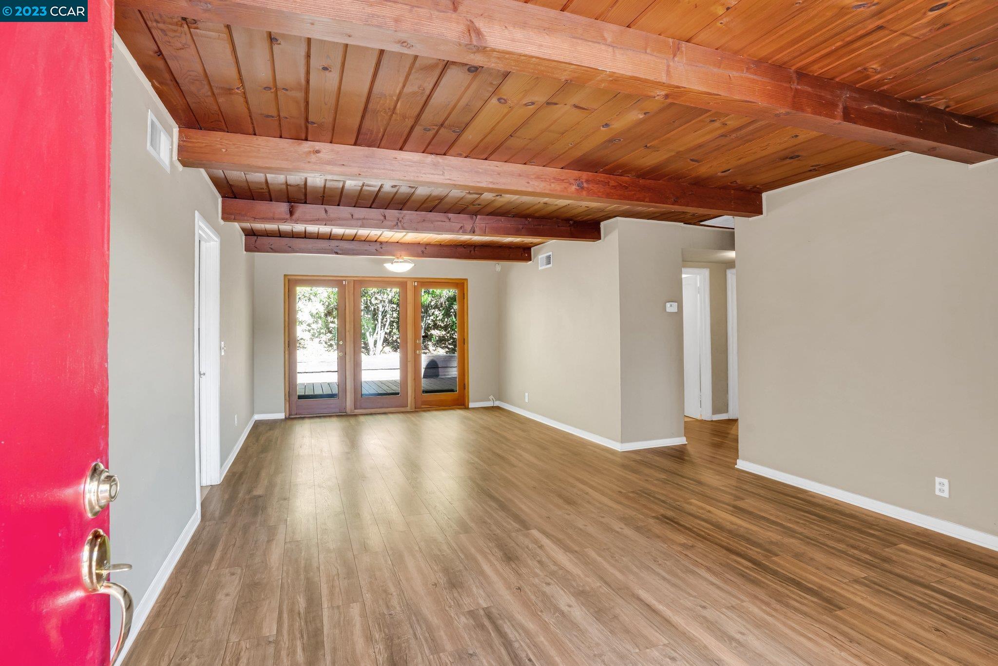 928 Janet Lane Lafayette, CA 94549 - Photo 3 of 33 a view of an empty room with wooden floor and a window