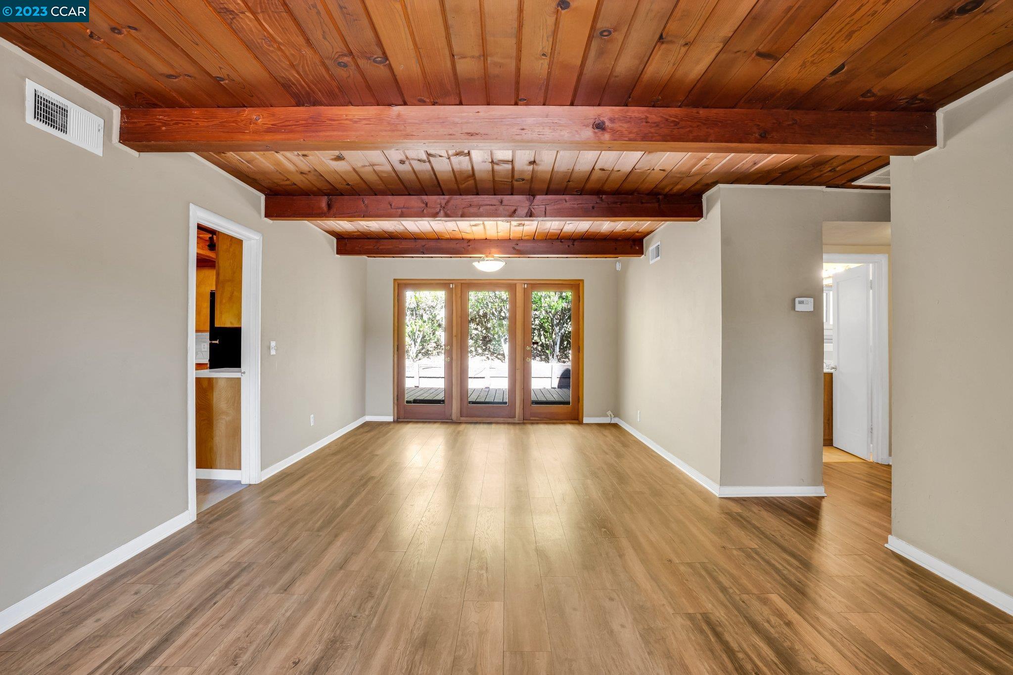 928 Janet Lane Lafayette, CA 94549 - Photo 4 of 33 a view of an empty room with wooden floor and a window