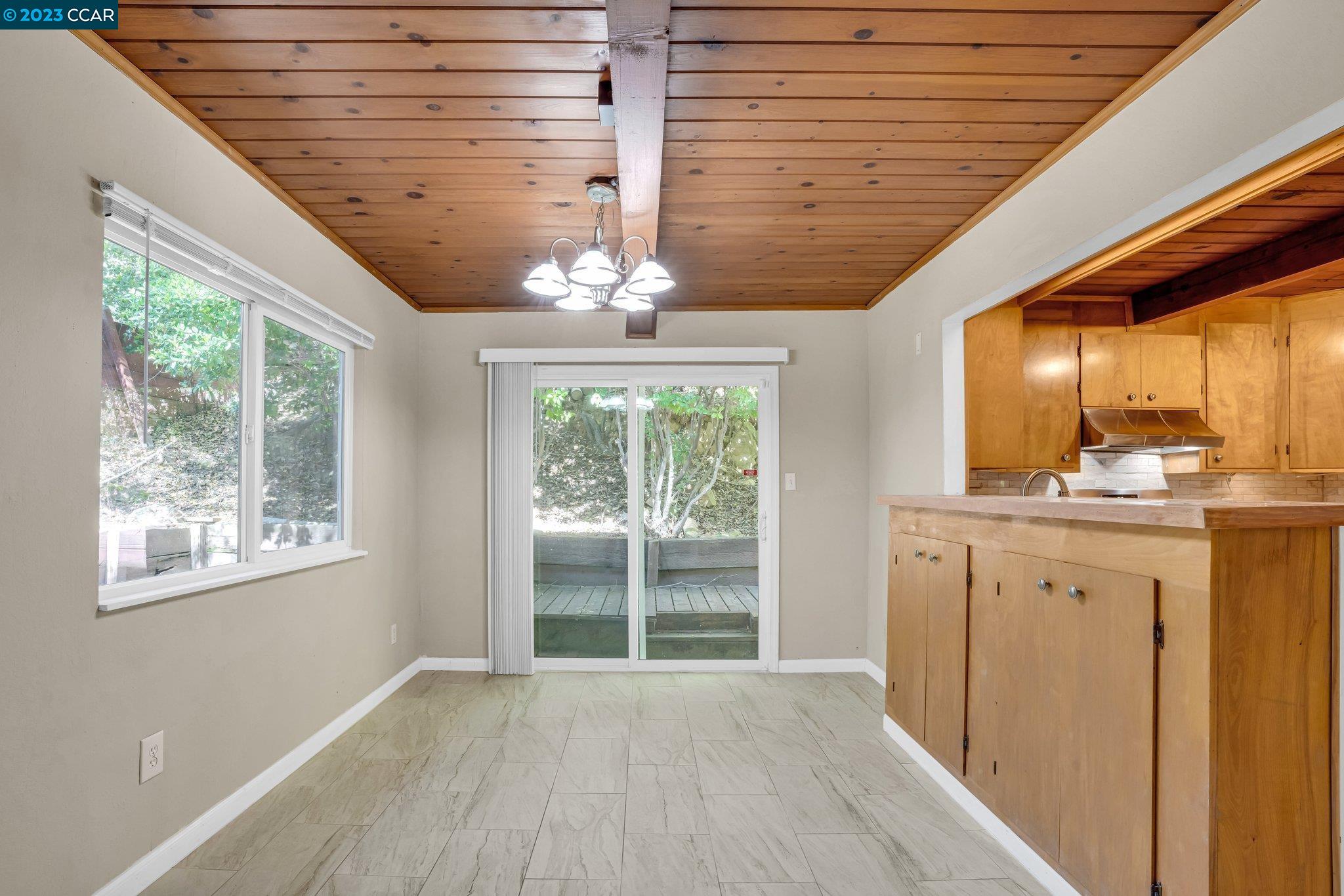 928 Janet Lane Lafayette, CA 94549 - Photo 9 of 33 a view of an empty room with a window and wooden floor