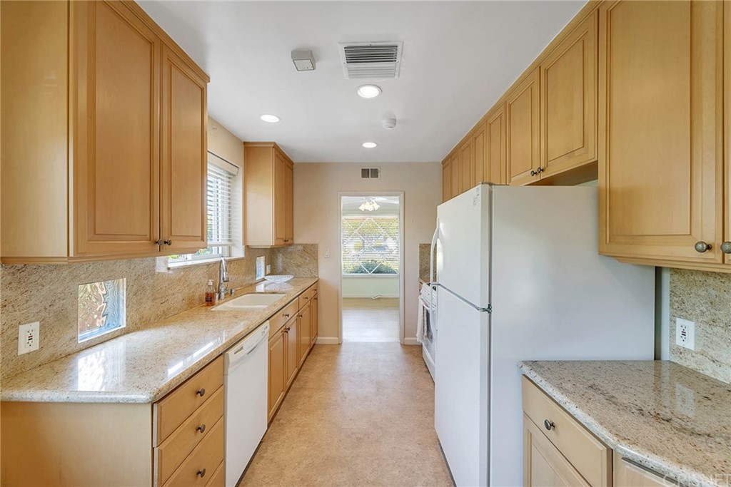 4906 Van Noord Avenue Sherman Oaks, CA 91423 - Photo 16 of 39 a kitchen with a sink a refrigerator and cabinets