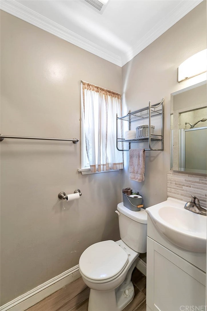 4906 Van Noord Avenue Sherman Oaks, CA 91423 - Photo 23 of 39 a bathroom with a sink a toilet and shower