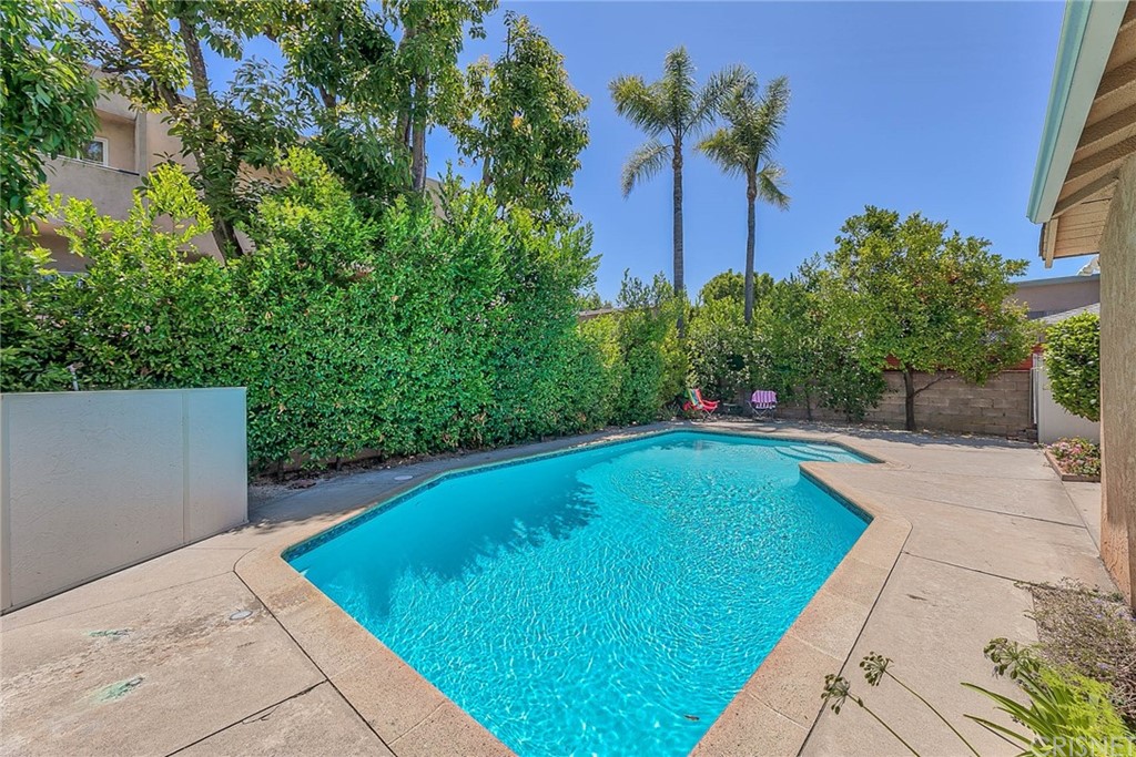 4906 Van Noord Avenue Sherman Oaks, CA 91423 - Photo 35 of 39 a view of a swimming pool with a yard