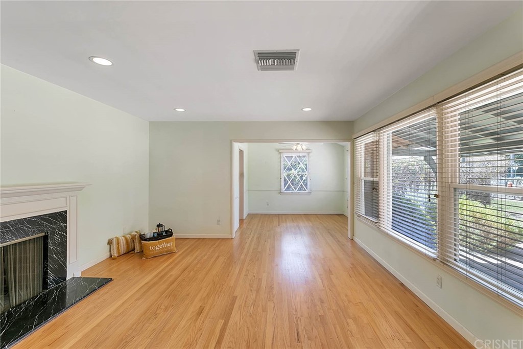 4906 Van Noord Avenue Sherman Oaks, CA 91423 - Photo 4 of 39 a view of an empty room with wooden floor and a window