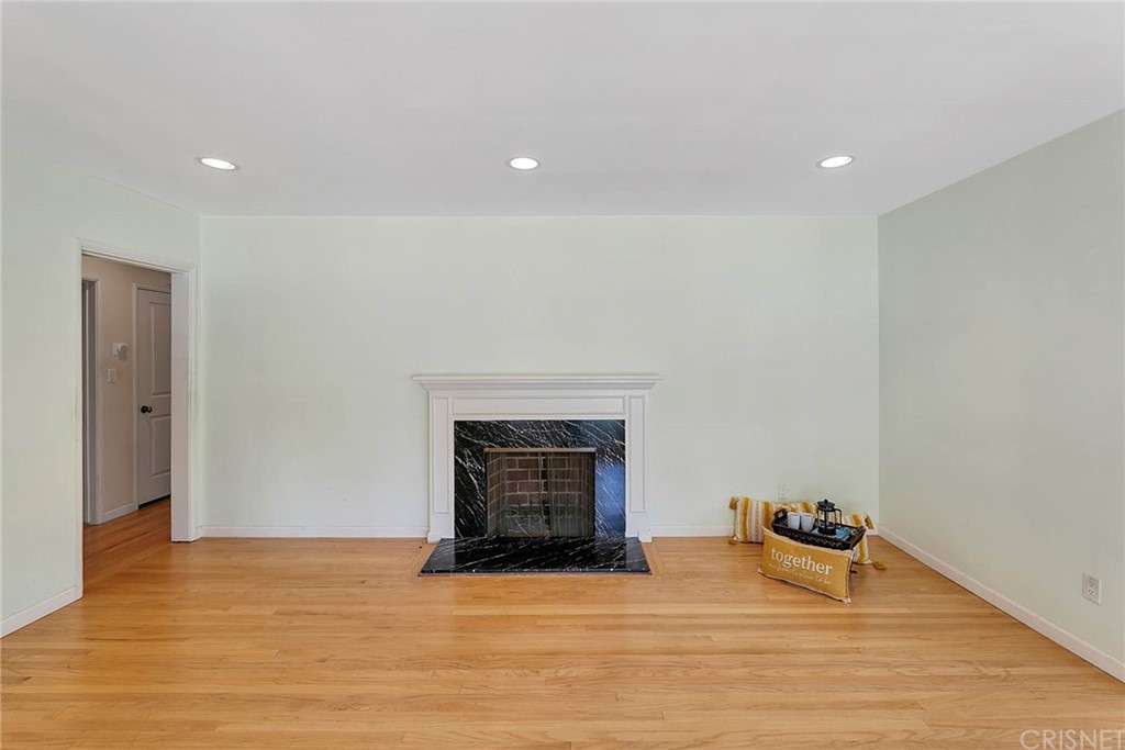4906 Van Noord Avenue Sherman Oaks, CA 91423 - Photo 6 of 39 a view of empty room with wooden floor and fireplace