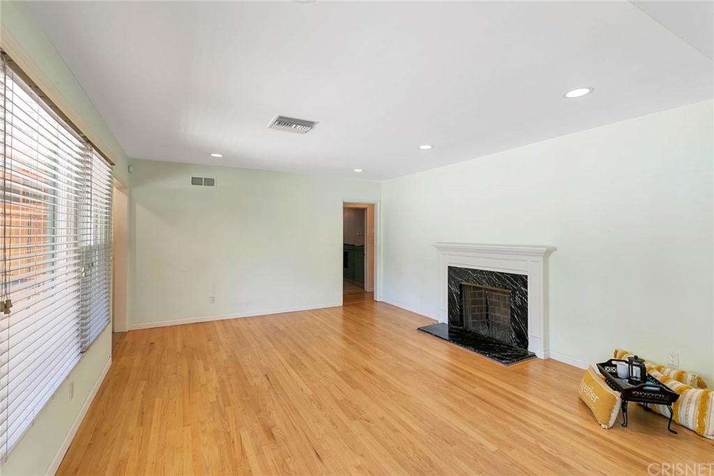 4906 Van Noord Avenue Sherman Oaks, CA 91423 - Photo 7 of 39 a view of empty room with wooden floor and fireplace