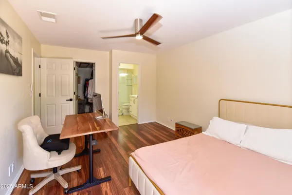 a bed room with two bed and a chair