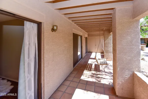 a hallway with white doors wooden floor and dining table