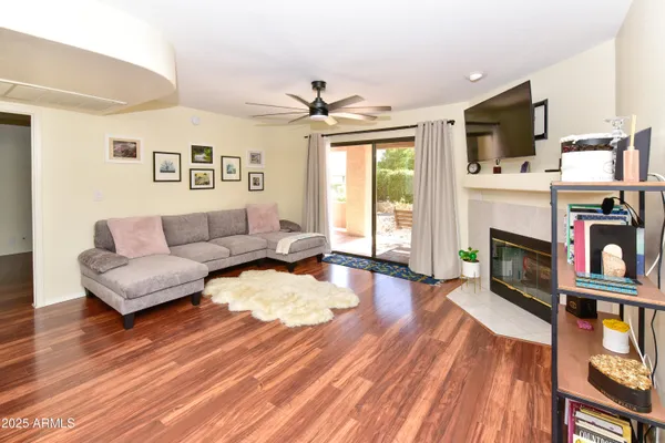 a living room with fireplace furniture and a flat screen tv