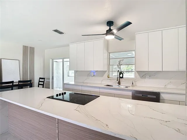 a kitchen with stainless steel appliances a refrigerator and a sink