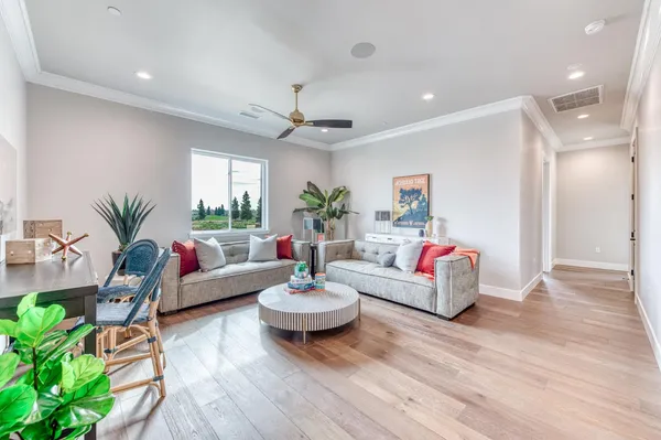 a living room with furniture and a wooden floor