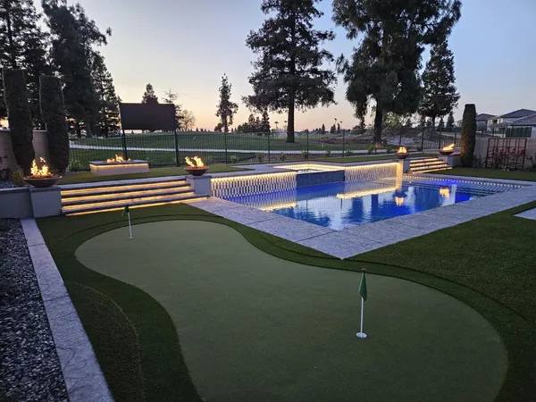a view of a swimming pool with outdoor seating and plants