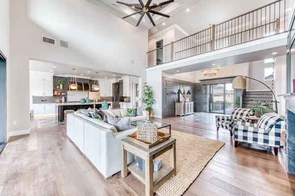 a living room with furniture and view of kitchen